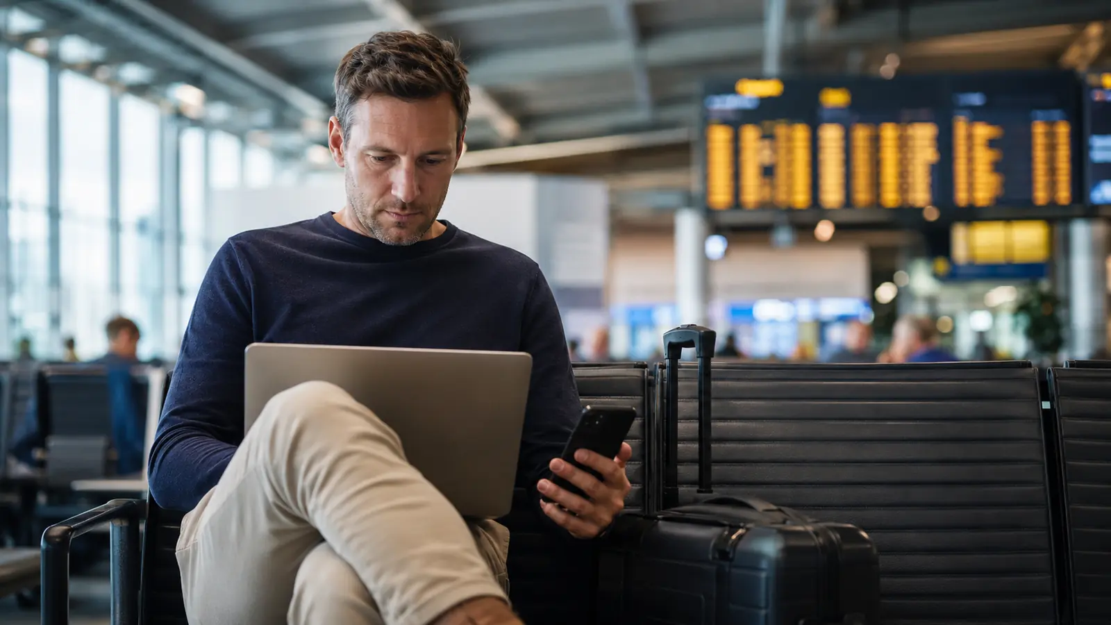 Traveller reviewing a flight confirmation email at an airport